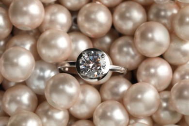 Beautiful decor pearls and engagement ring, top view