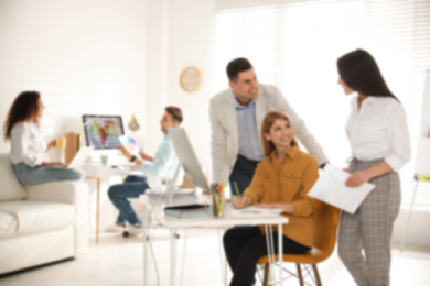Blurred view of professional interior designers working in office