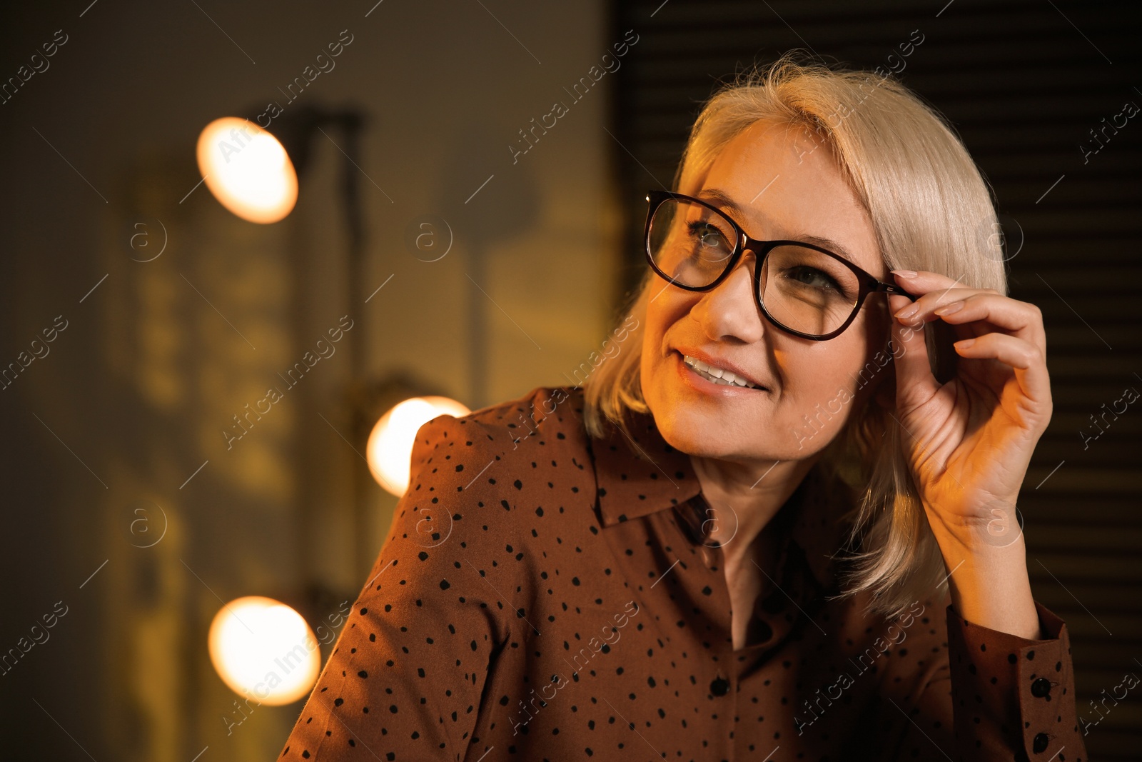 Photo of Beautiful mature woman in glasses at home