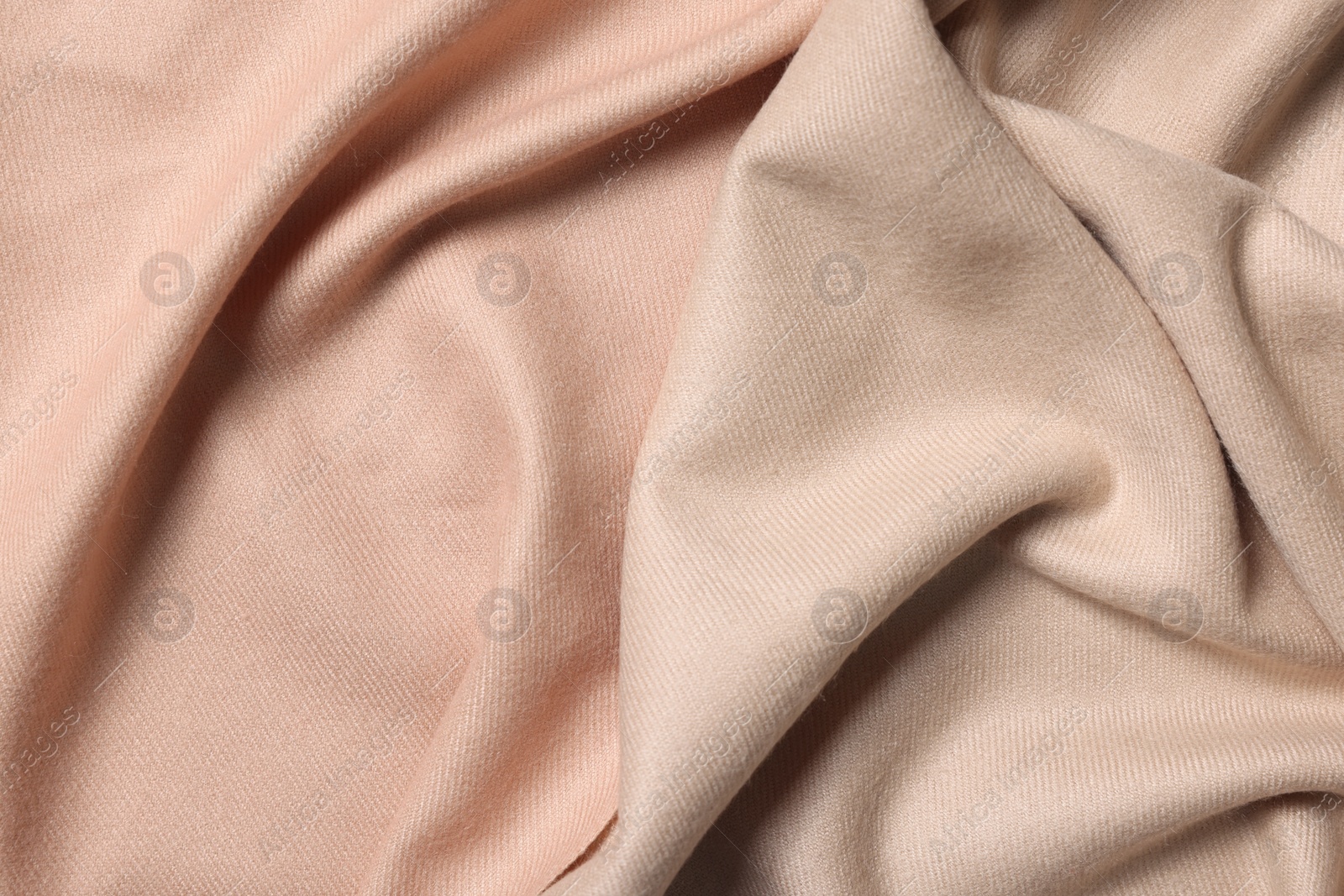 Photo of Texture of beige crumpled fabric as background, top view