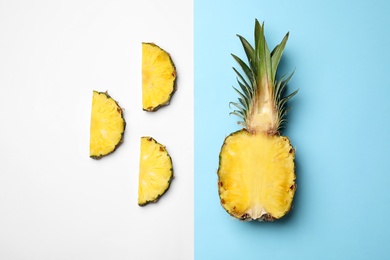 Photo of Flat lay composition with cut and fresh juicy pineapples on color background