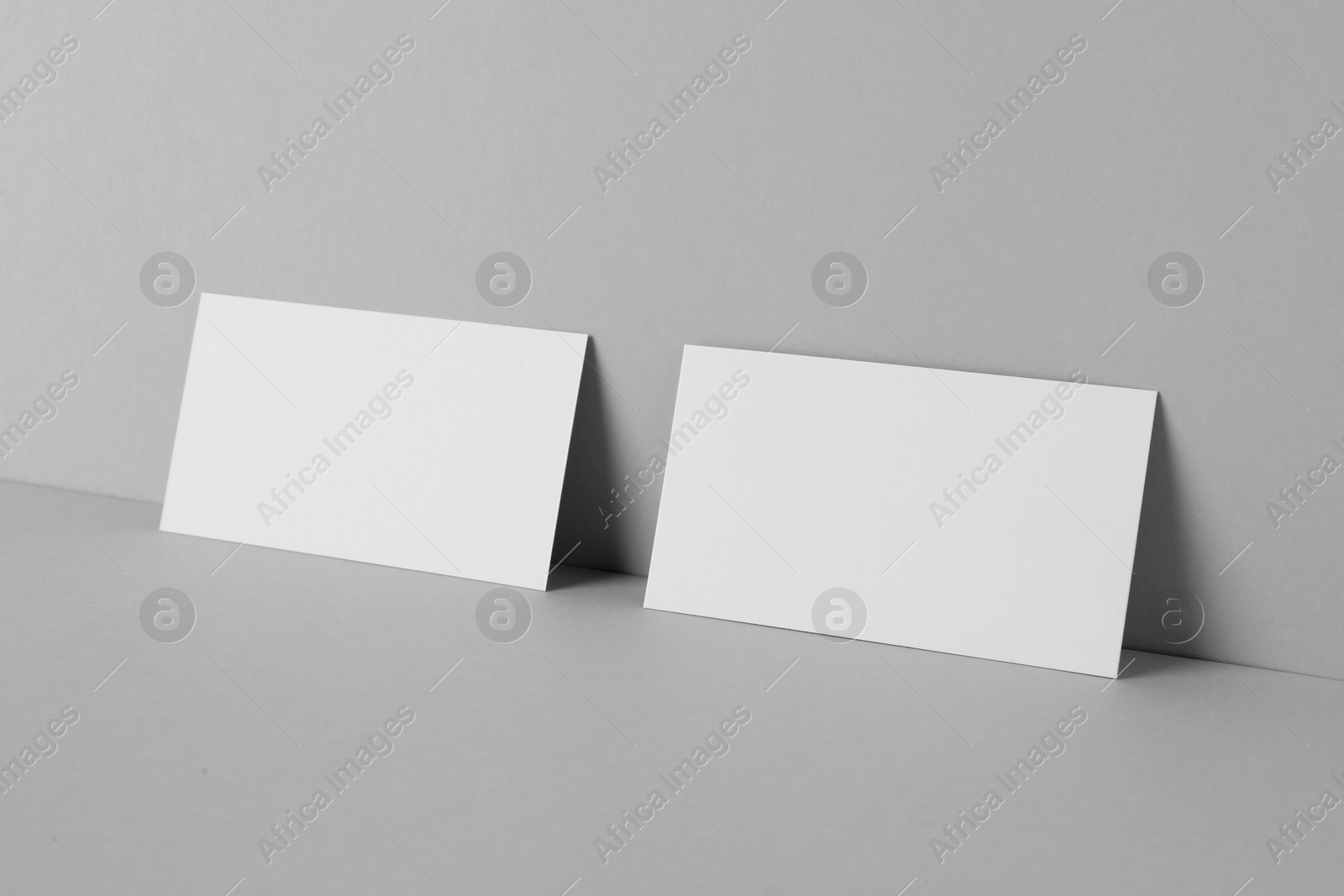 Photo of Blank business cards on light gray background. Mockup for design