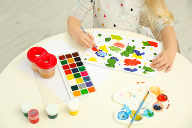 Little child painting at light table, closeup