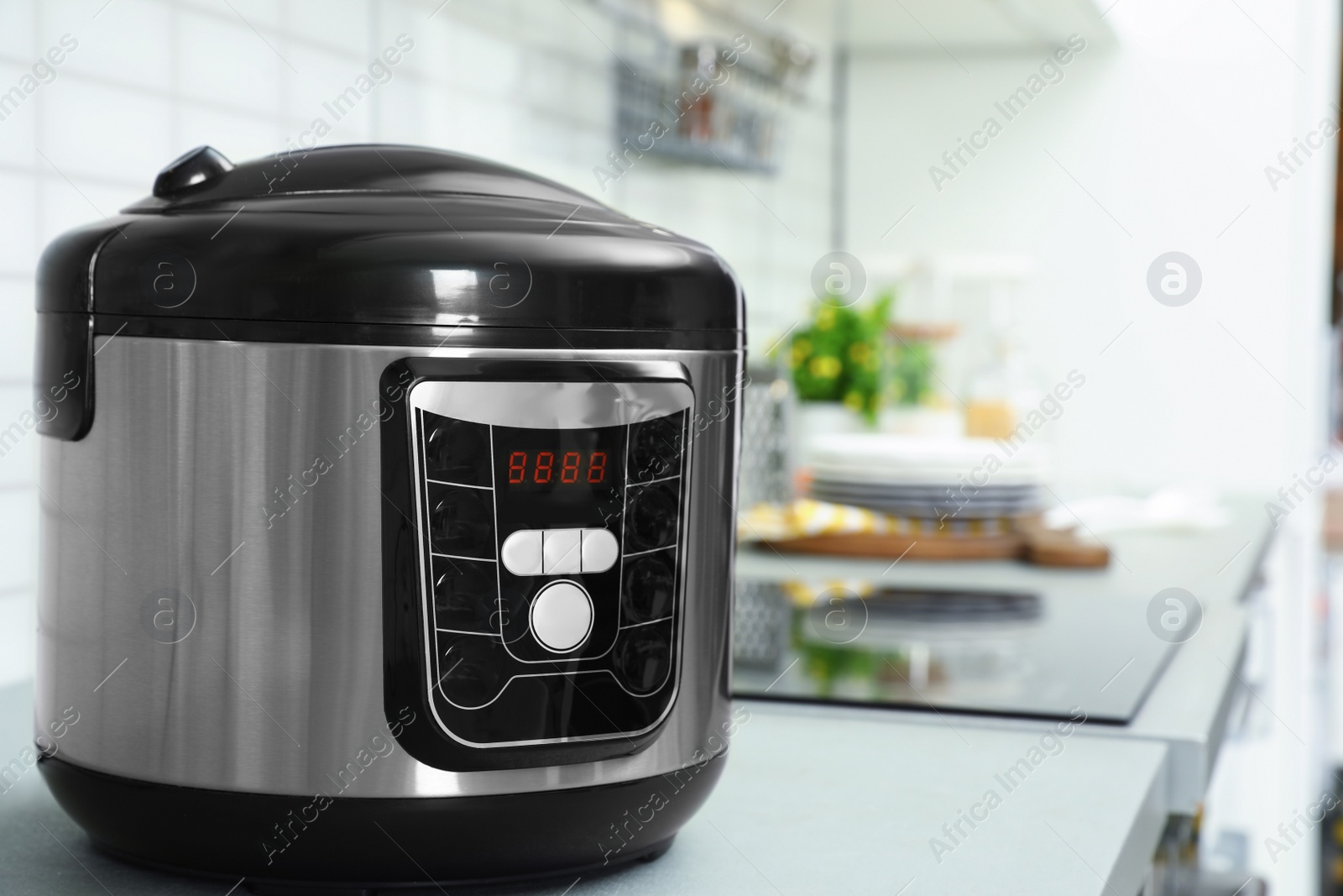 Photo of Modern multi cooker on table in kitchen. Space for text