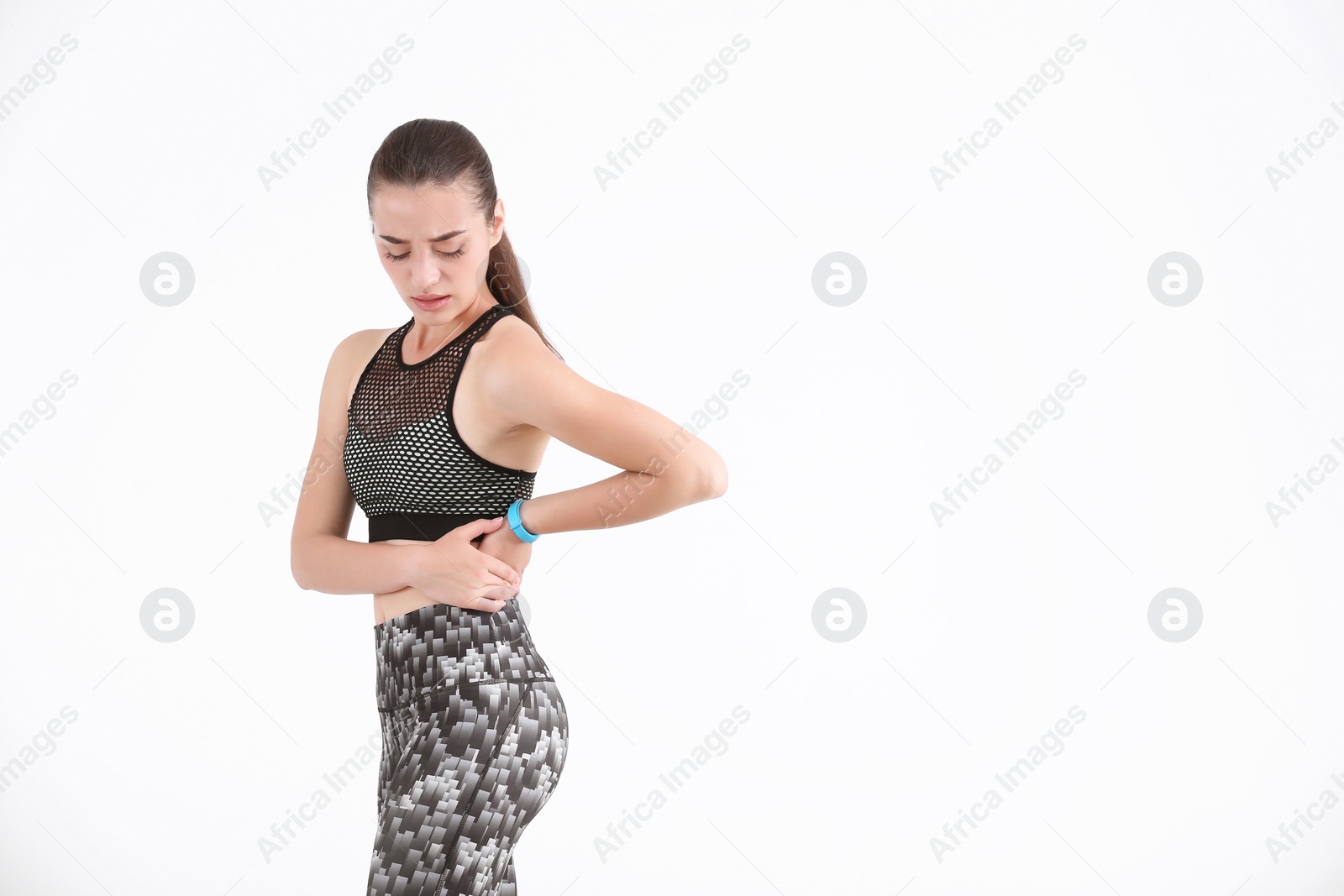 Photo of Woman in sportswear suffering from flank pain on white background