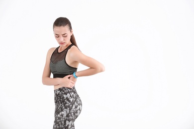 Photo of Woman in sportswear suffering from flank pain on white background