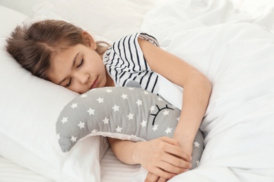 Photo of Cute girl with toy sleeping in bed