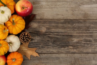 Thanksgiving day. Flat lay composition with pumpkins on wooden table, space for text