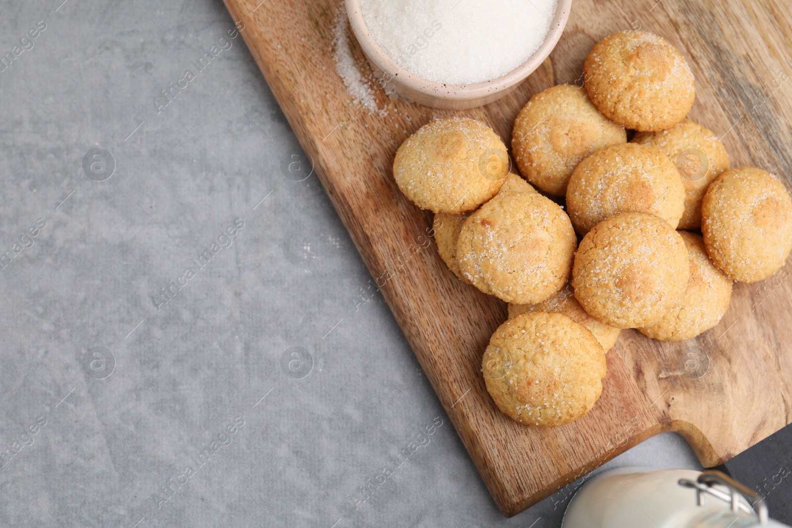 Photo of Tasty fresh sugar cookies on grey table, top view. Space for text