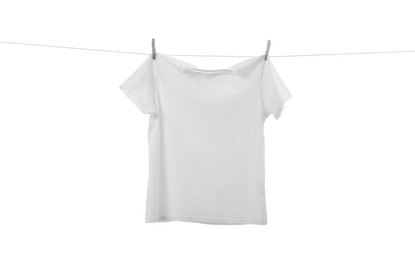 One t-shirt drying on washing line isolated on white