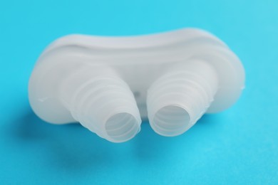 Photo of Anti-snoring device for nose on light blue background, closeup