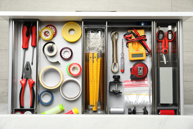 Set of instruments in open desk drawer, top view