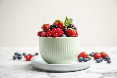 Photo of Mix of ripe berries on white marble table