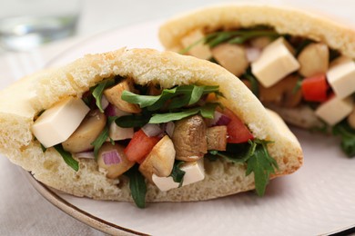 Photo of Delicious pita sandwiches with cheese, mushrooms tomatoes and arugula on table, closeup