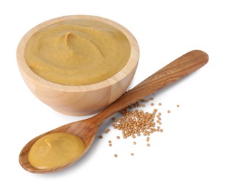 Photo of Fresh tasty mustard sauce in wooden bowl, spoon and dry seeds isolated on white