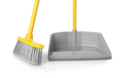 Photo of Plastic broom and dustpan on white background