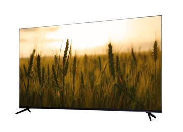 Image of Modern wide screen TV monitor showing beautiful wheat field at sunset isolated on white