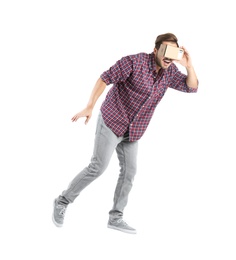 Young man using cardboard virtual reality headset, isolated on white