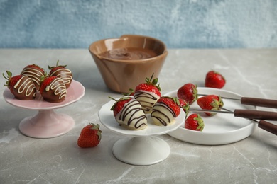 Photo of Delicious chocolate covered strawberries on grey table