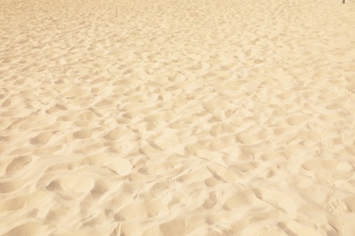 Golden beach sand on sunny day as background