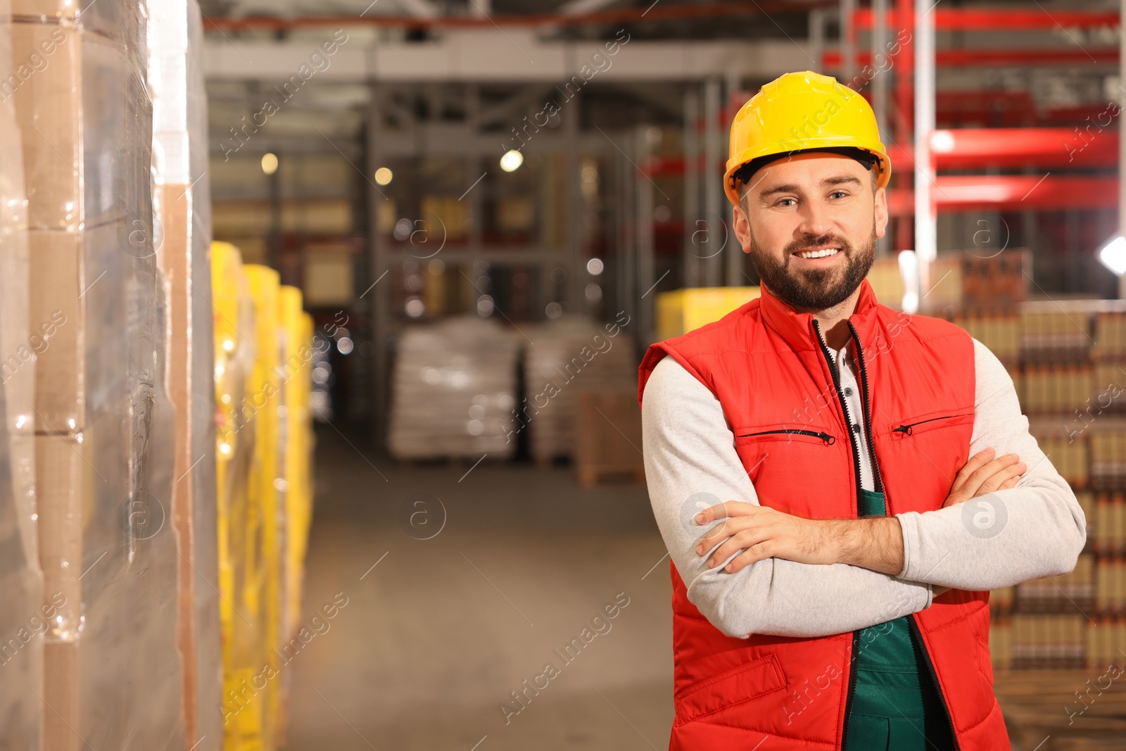 Image of Worker in hardhat and uniform at warehouse. Logistics center