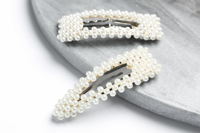 Photo of Stylish hair clips and board on white background