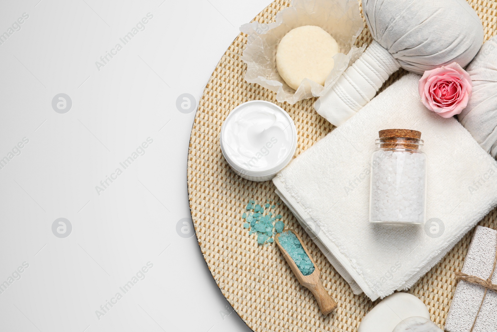 Photo of Beautiful spa composition with herbal massage bags and different care products on white background, top view. Space for text