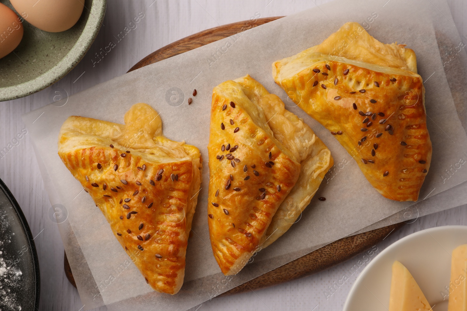 Photo of Fresh delicious puff pastry on white wooden table, top view