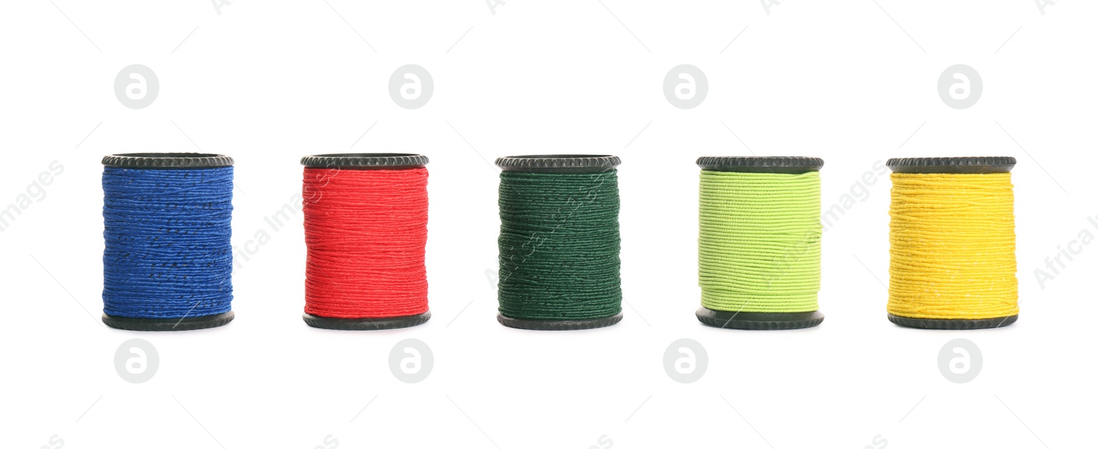 Photo of Set of colorful sewing threads on white background