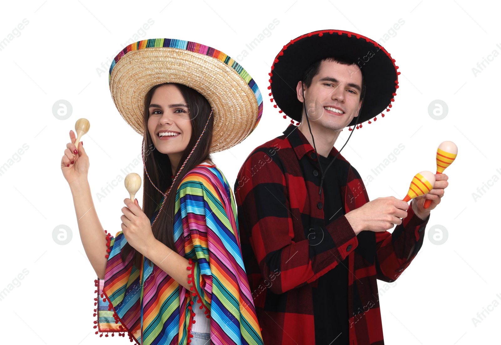 Photo of Lovely couple in Mexican sombrero hats with maracas on white background