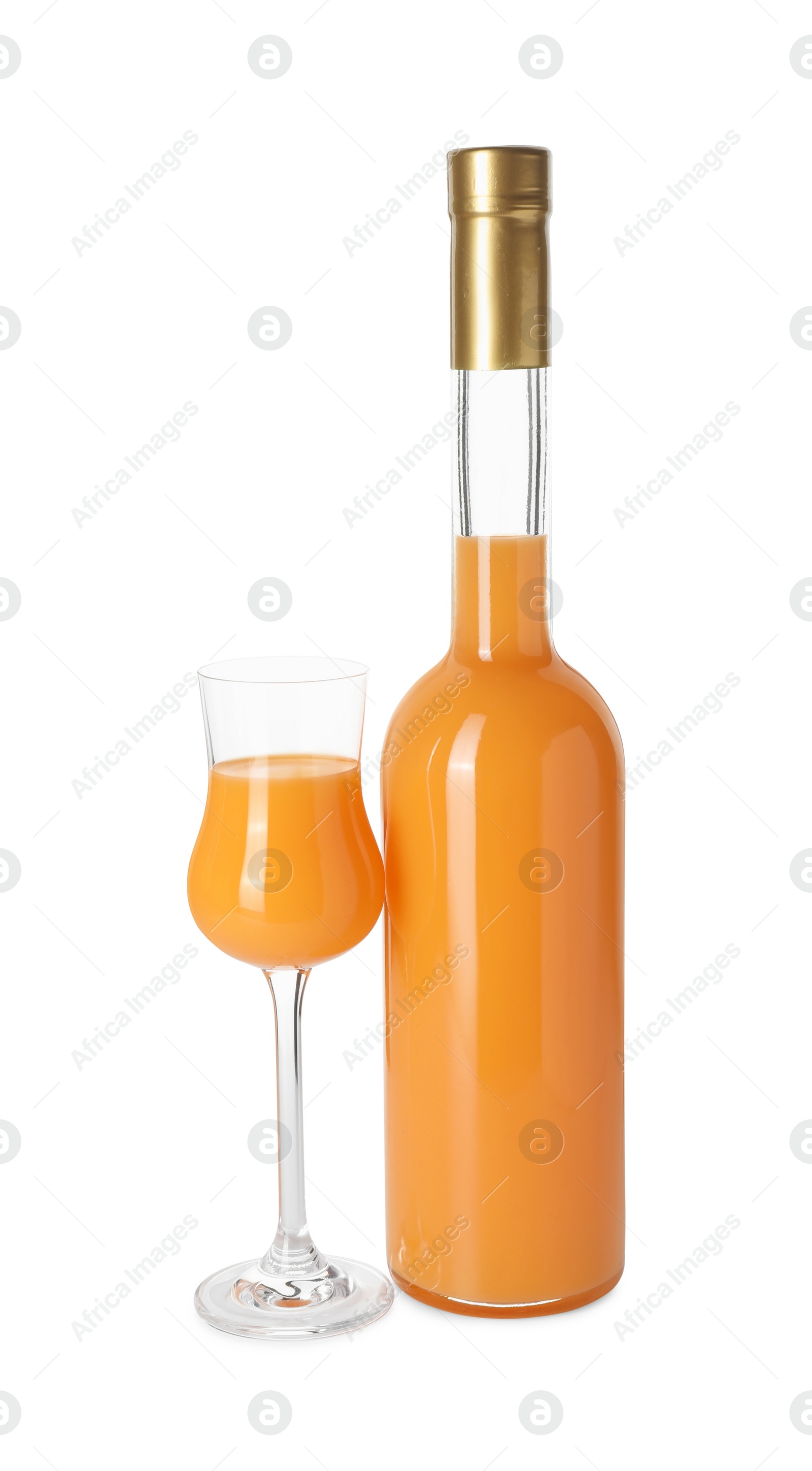 Photo of Bottle and glass with tasty tangerine liqueur isolated on white