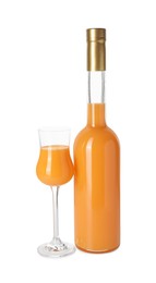 Bottle and glass with tasty tangerine liqueur isolated on white
