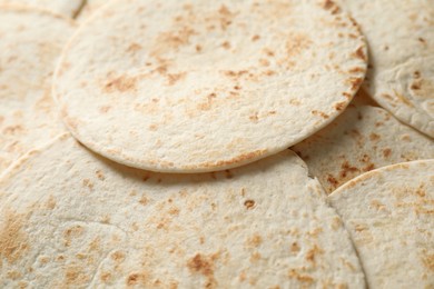 Photo of Many tasty homemade tortillas as background, closeup