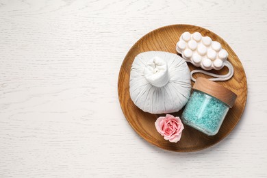 Photo of Composition of herbal bag and spa products on white wooden table, top view. Space for text