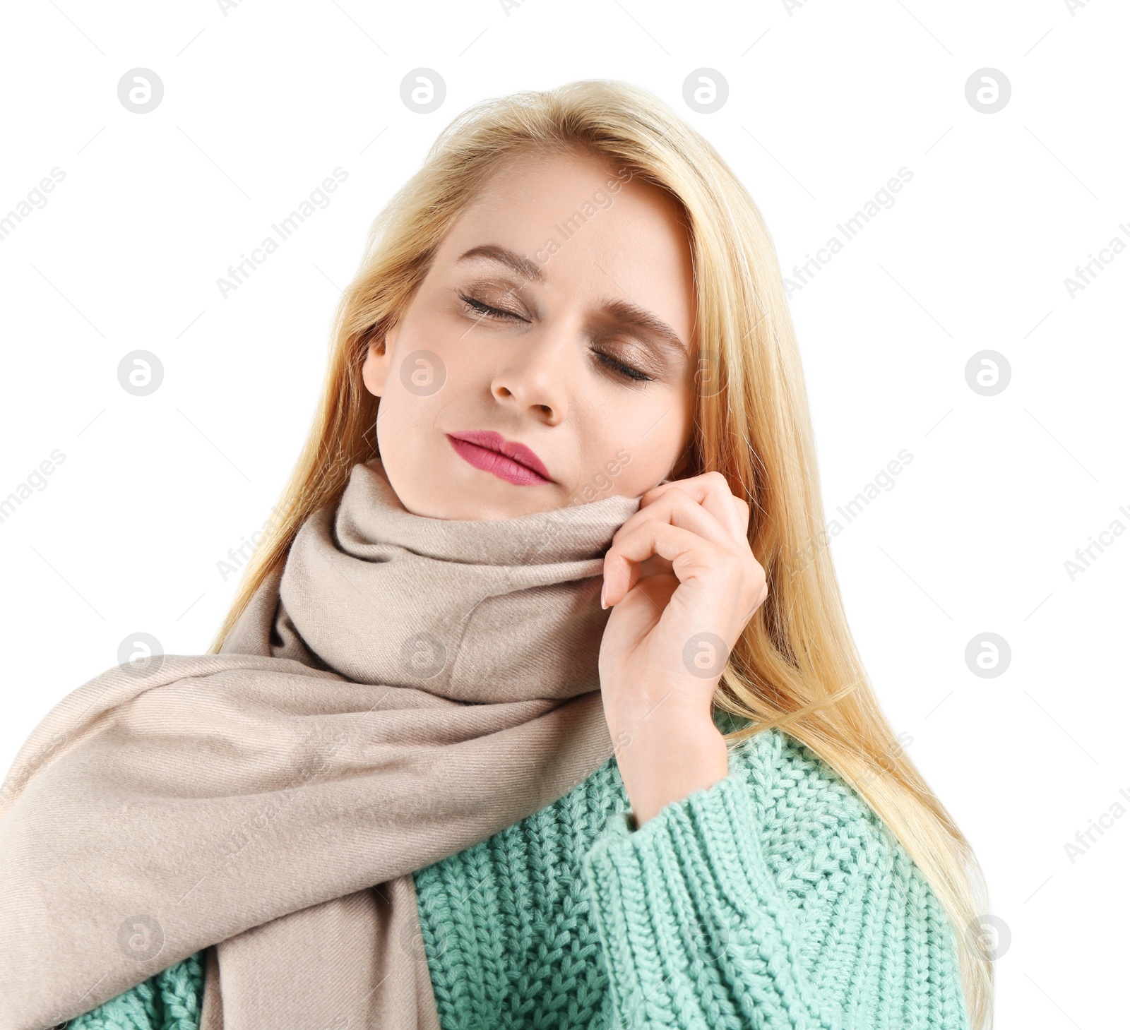 Image of Pretty young woman wearing warm sweater and scarf on white background