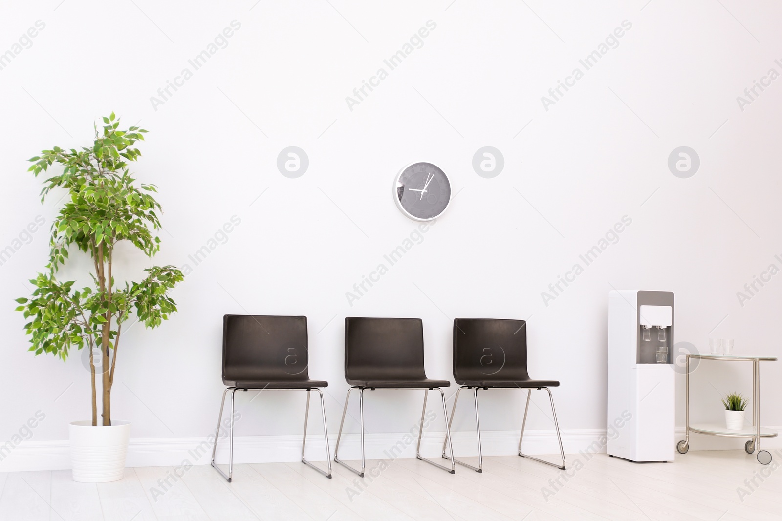 Photo of Modern water cooler in stylish office interior