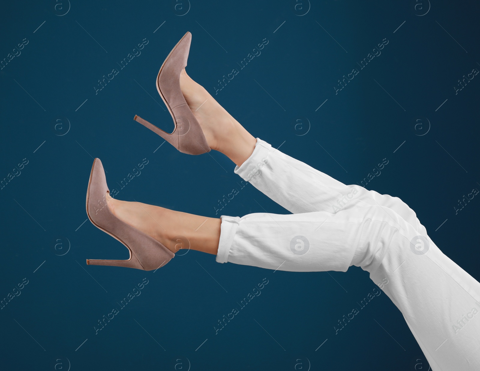 Photo of Woman in elegant shoes on dark blue background