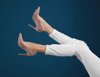 Photo of Woman in elegant shoes on dark blue background