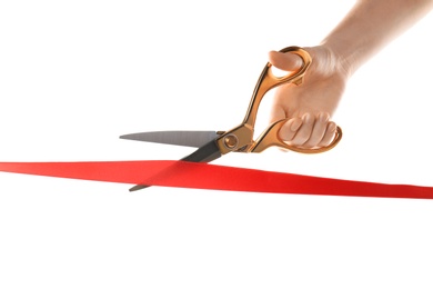 Photo of Woman cutting red ribbon on white background