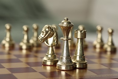 Photo of Golden bishop, knight and rook on chess board, closeup. Space for text
