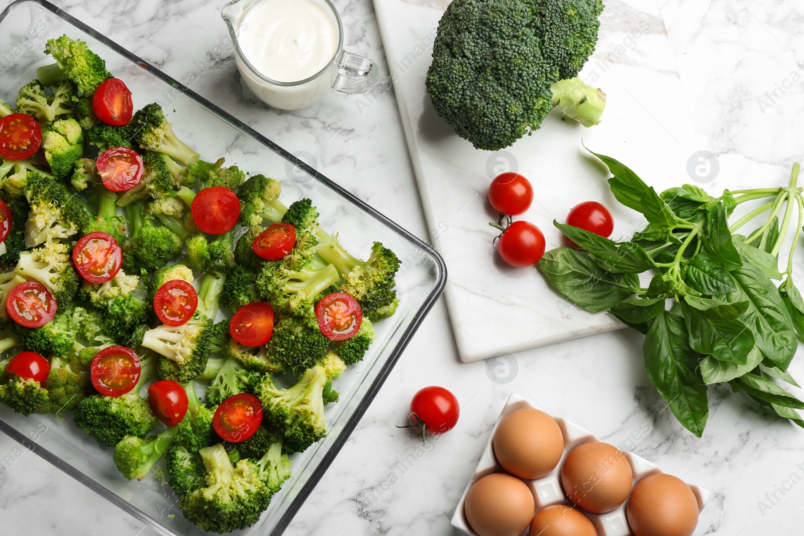 Photo of Flat lay composition with ingredients for tasty broccoli casserole on white marble table