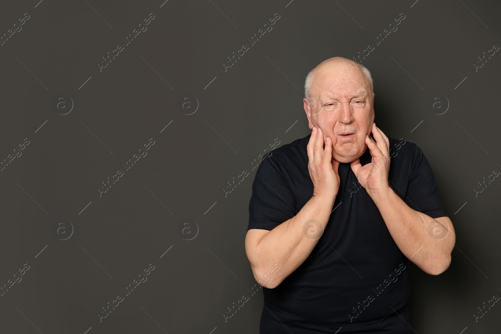 Photo of Senior man suffering from cough on dark background. Space for text