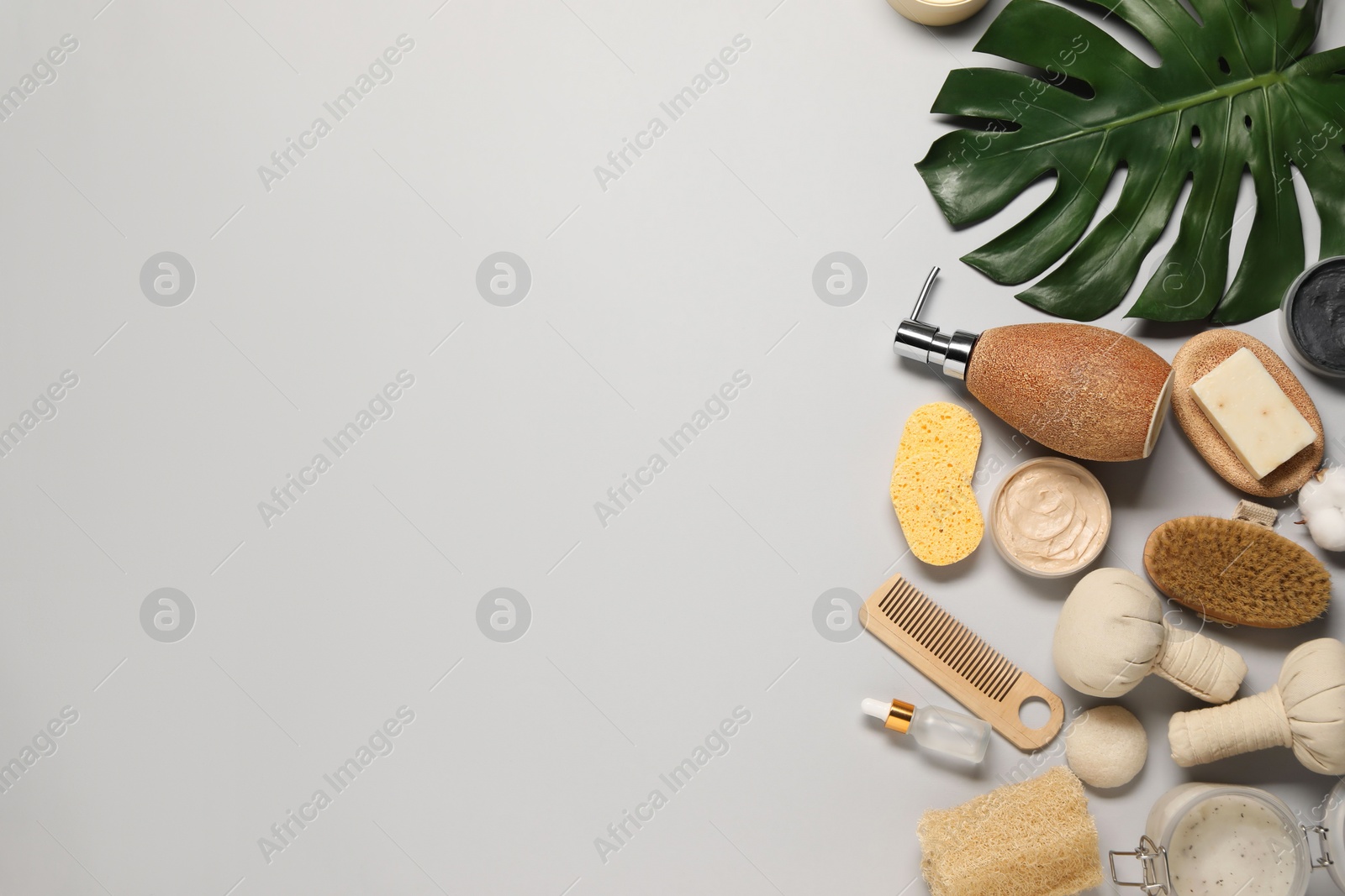 Photo of Bath accessories. Flat lay composition with personal care products on light grey background, space for text