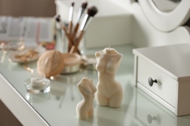 Beautiful body shaped candles on dressing table indoors, space for text