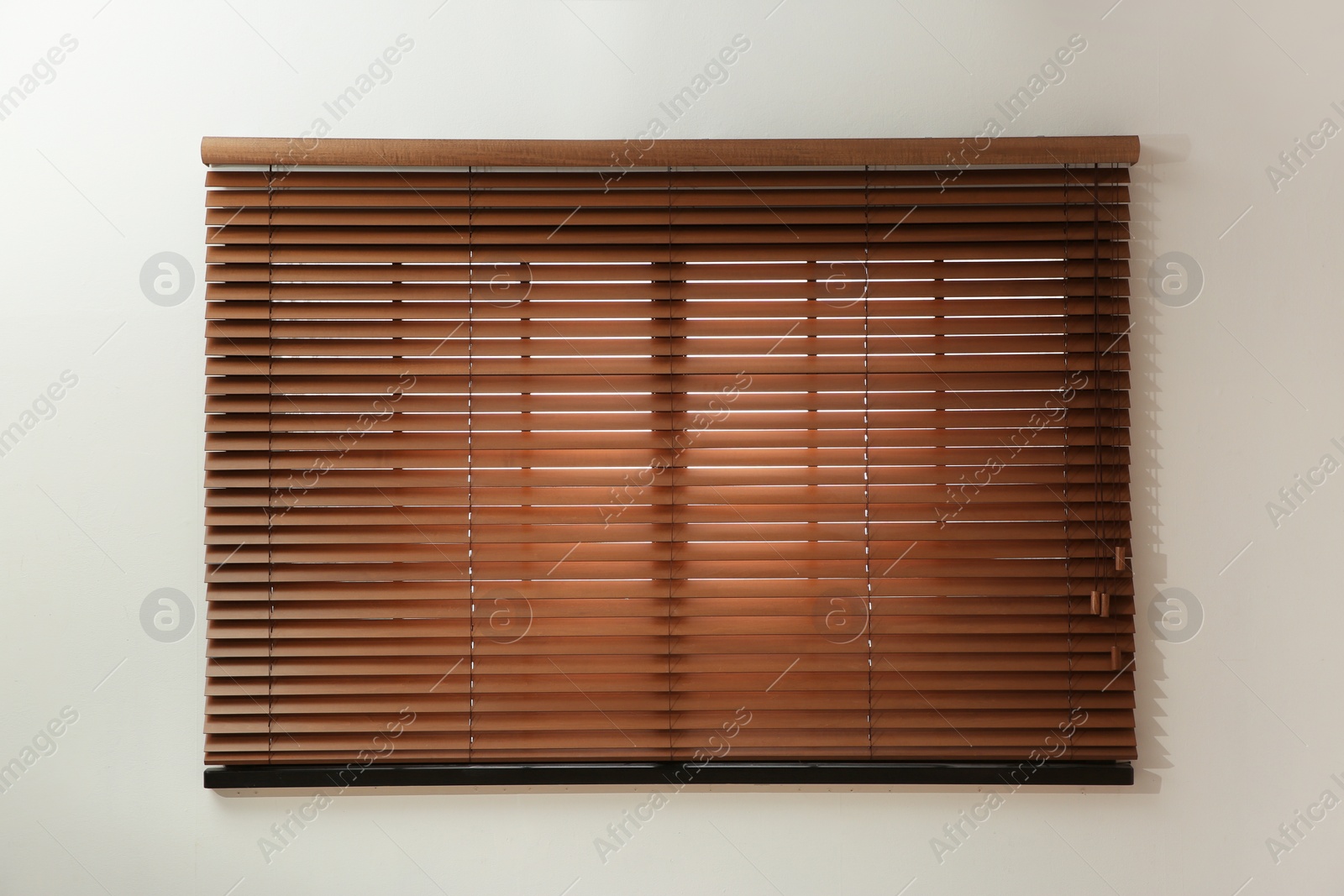 Photo of Window with closed brown blinds in room