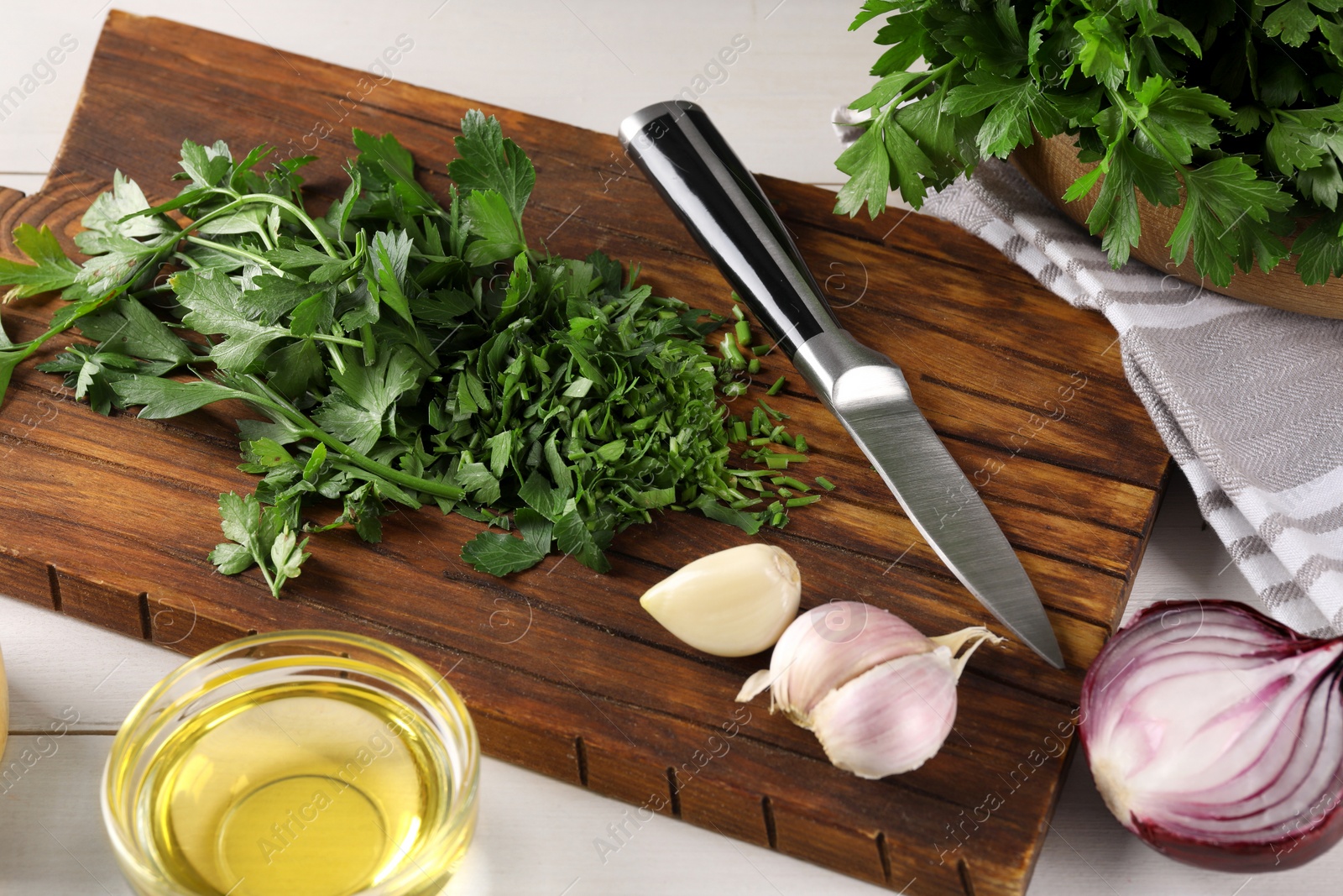 Photo of Fresh green parsley and different products on white wooden table