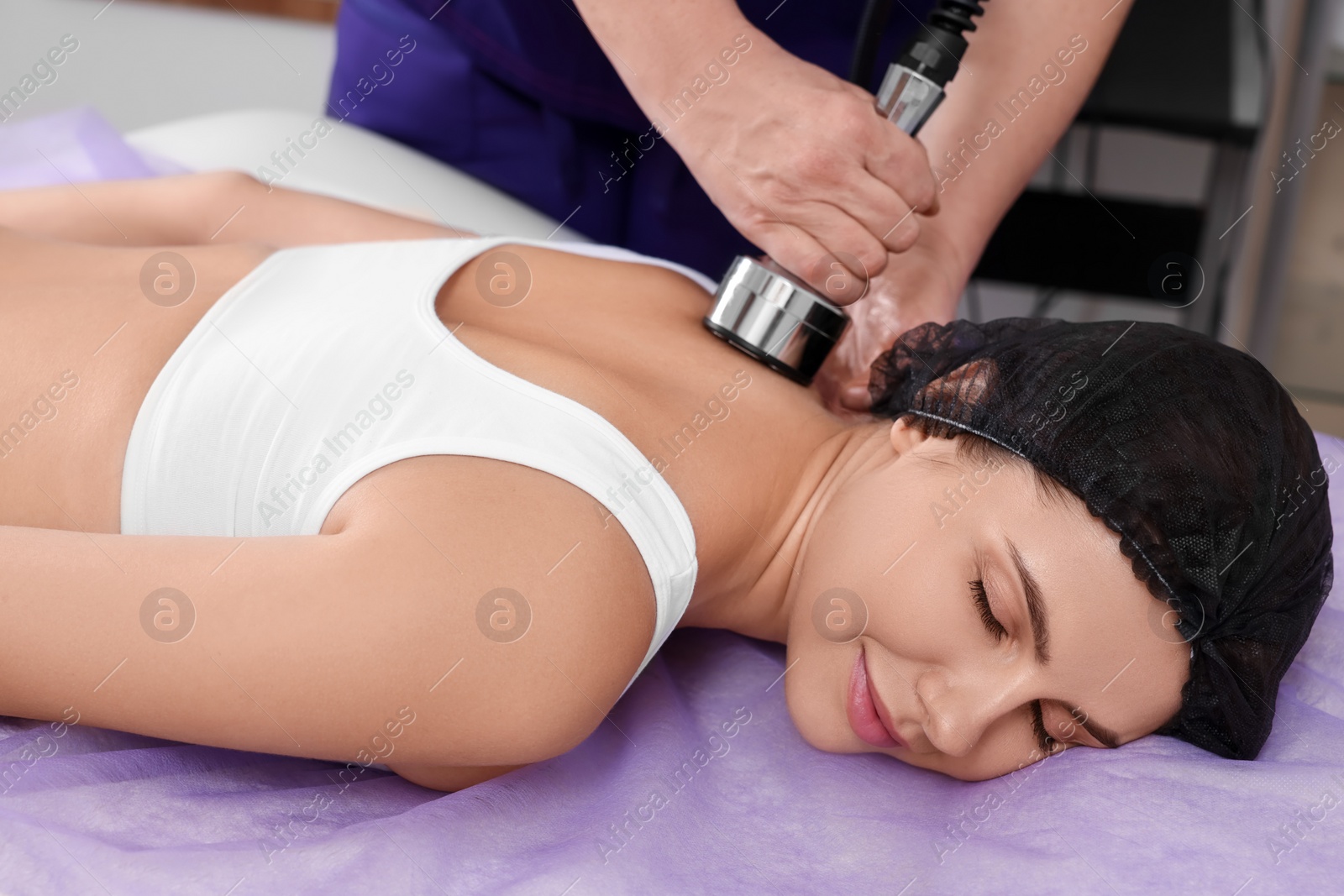 Photo of Woman undergoing radio frequency lifting procedure in beauty salon, closeup