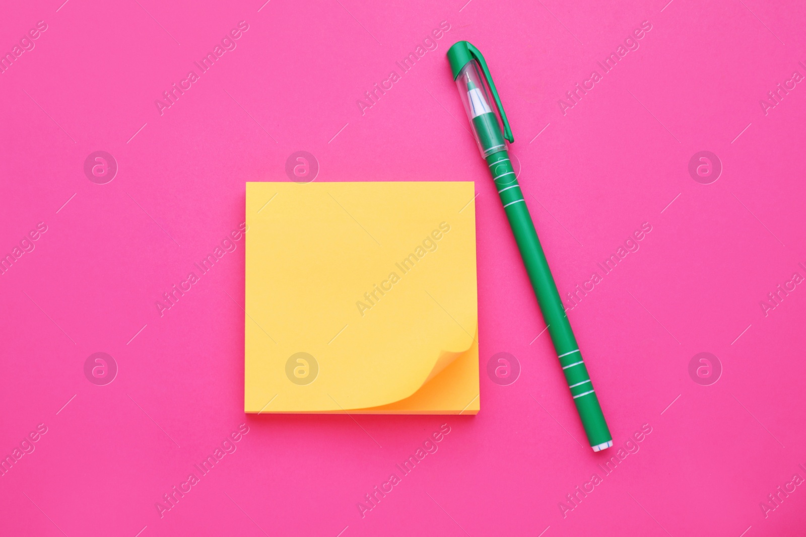 Photo of Empty notes and pen on pink background, flat lay