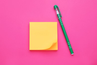 Photo of Empty notes and pen on pink background, flat lay
