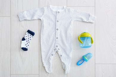 Photo of Flat lay composition with fashionable children's clothes on wooden background